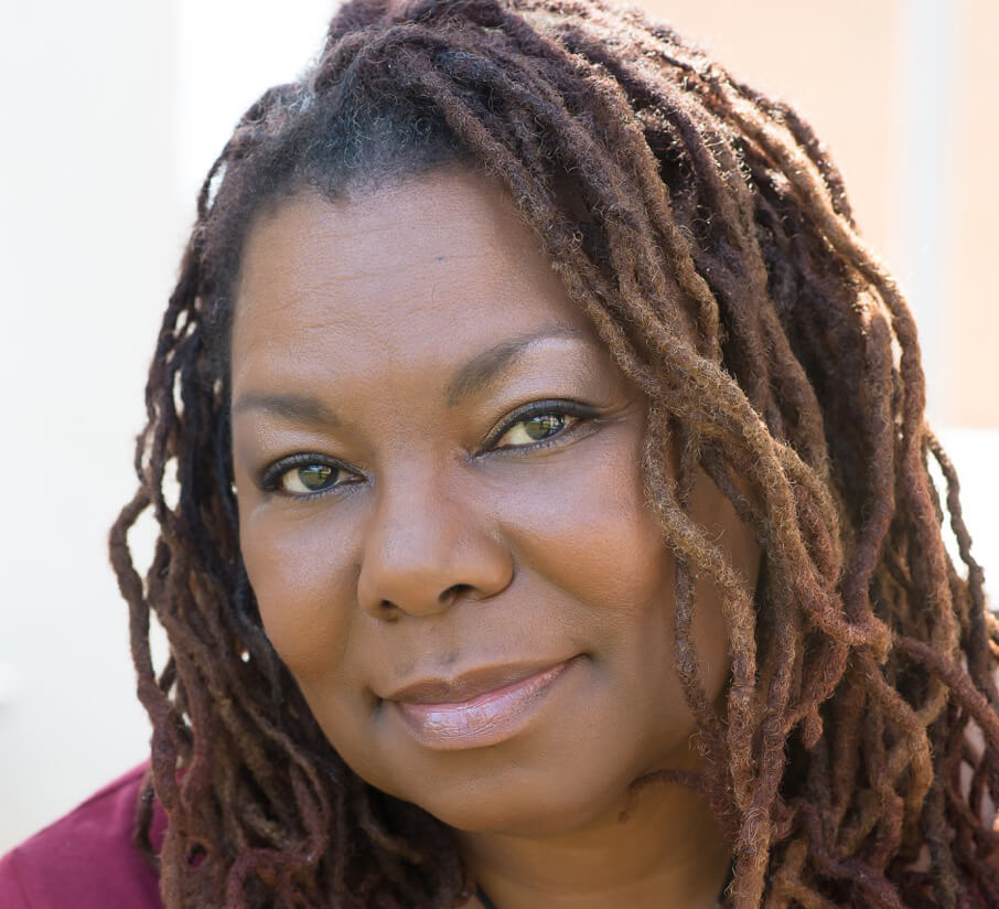 Playwright Deletta Gillespie - a middle-aged Black woman with dreadlocks and a gentle smile